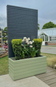 contemporary trellis fence panels in a sage green finish