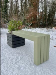 sage green wooden bench attached to a dark grey wooden planter