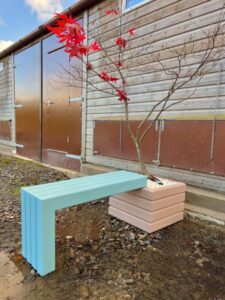 light blue wooden bench attached to a small square wooden planter