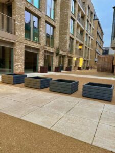 group of four square planters outside in a communal patio area