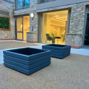 pair of dark grey square planters on a gravel surface