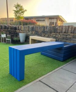 Blue wooden bench attached to a square blue wooden planter