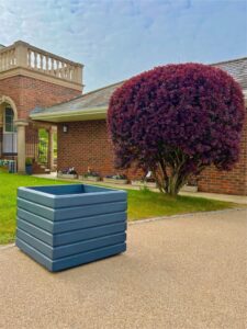 dark grey square planter in a communal garden